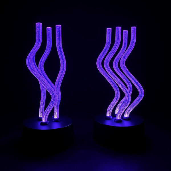 Modern decorative LED light sculpture with wavy acrylic tubes glowing in purple on black round base, aesthetic home decor lamp